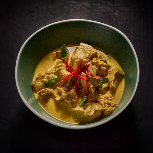 Young jackfruit in red curry with chicken.