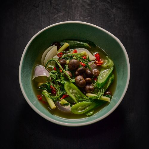 Herbal soup with mushrooms and local vegetables.