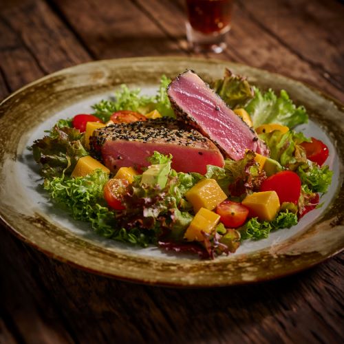 Tuna steak served with mango salad.