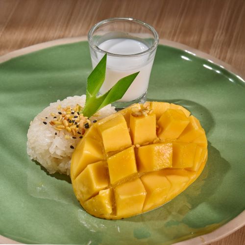 Thai traditional sticky rice with fresh mango, served with coconut milk.