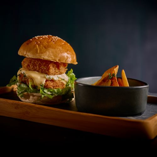 Crispy Shrimp Burger served with potato wedges.