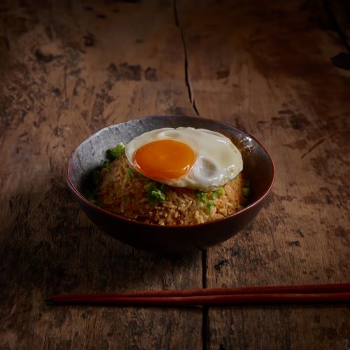 Salmon fried rice served with fried egg.