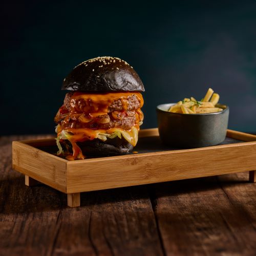 Beef Burger served with french fries.