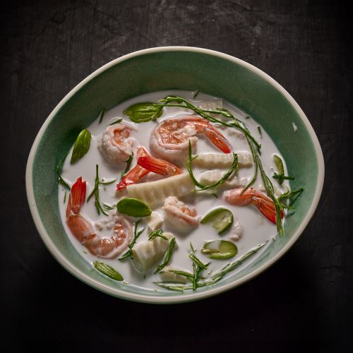 Coconut milk soup with prawns, bitter green beans and coconut shoots.